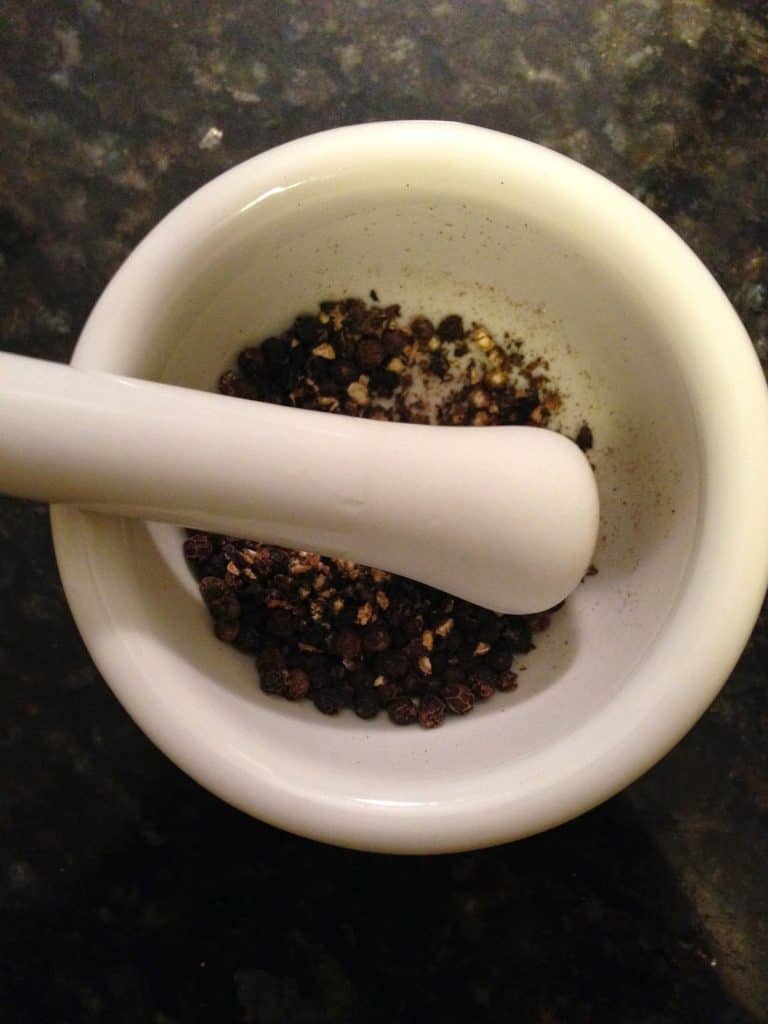 Coarse ground black pepper in mortar & pestle