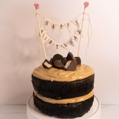 Chocolate cake with peanut butter frosting and Happy Birthday decoration