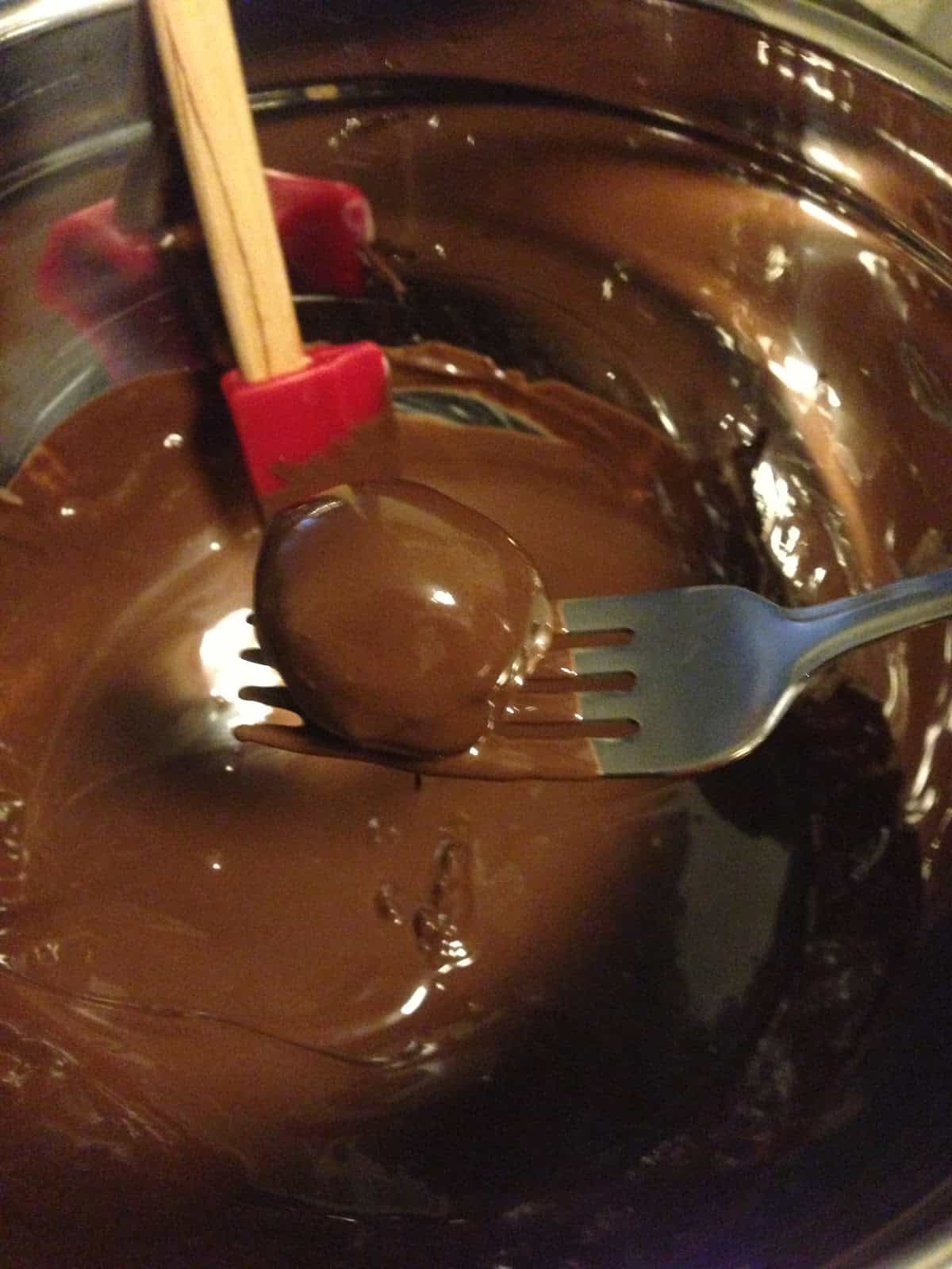 Dipping Buckeye Balls in chocolate