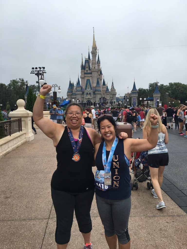 Posing in front of Sleeping Beauty castle with our race medals