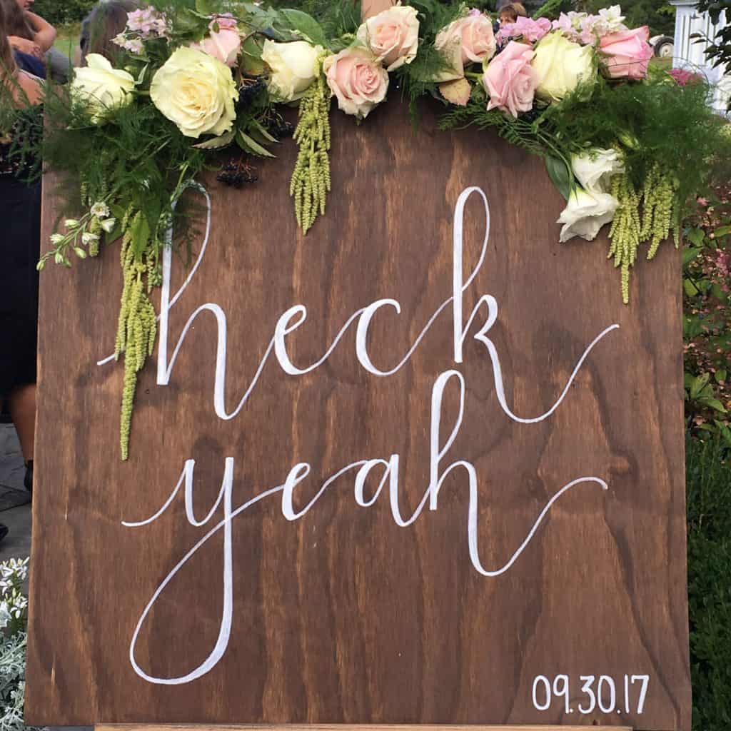 A wooden sign that says "Heck Yeah"
