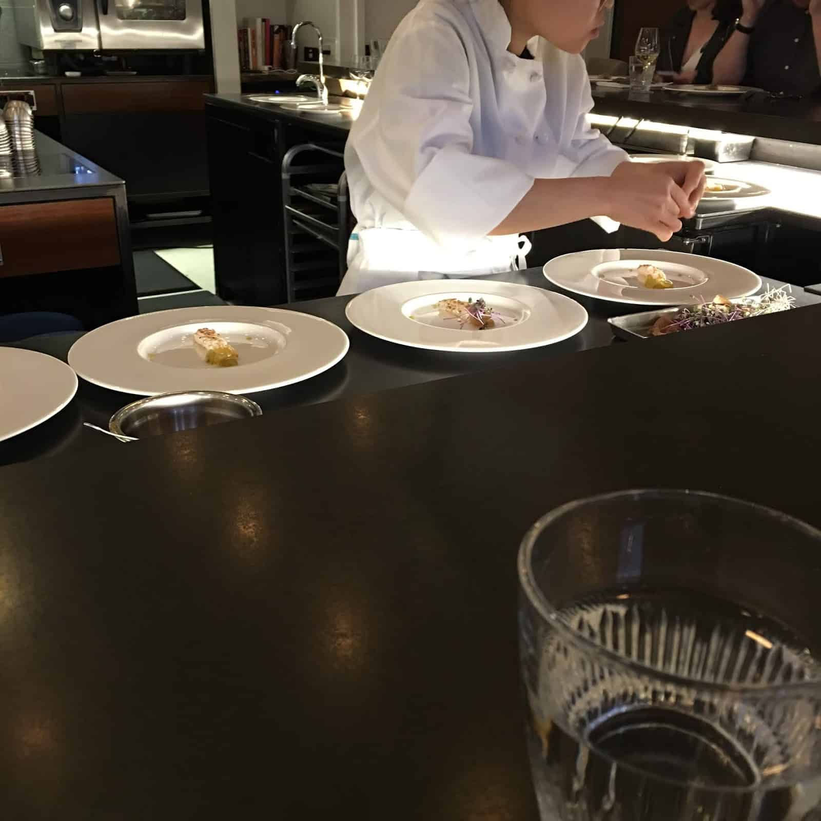 Plating dishes in front of guests at Tasting Counter