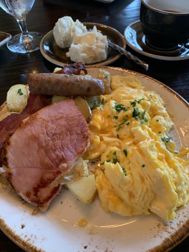 The Main Course - three eggs, bacon, ham steak, sausage, and potatoes