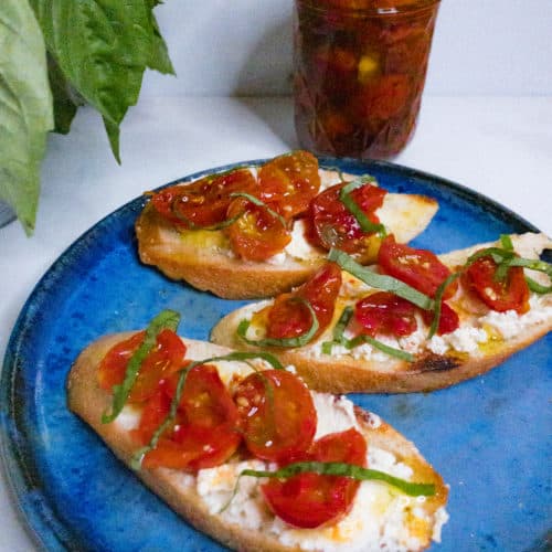 Confit tomatoes with goat cheese and basil on sourdough toast