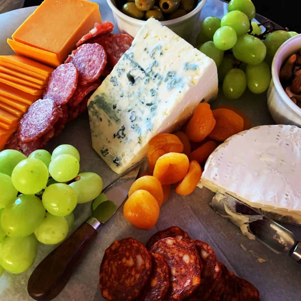 Holiday cheeseboard featuring a wedge of creamy blue cheese