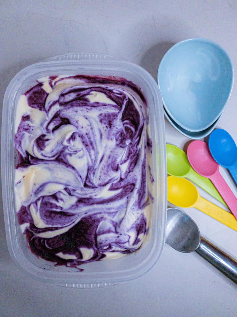 No-churn lemon ice cream with blueberry swirl - overhead view of tub