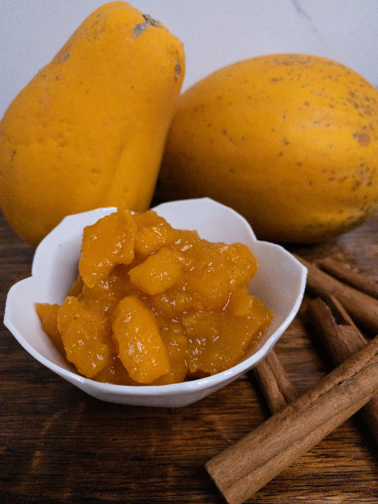 Spiced papaya compote with whole papaya and cinnamon sticks