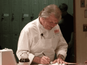 Jacques Pépin autographing a cookbook